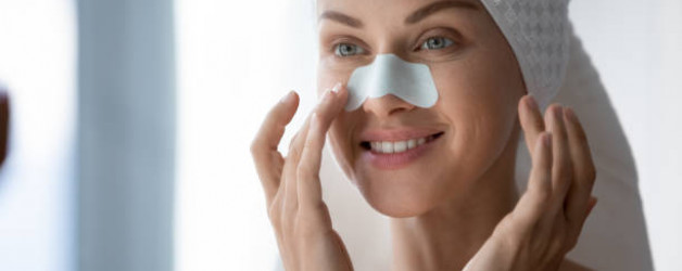 Close up 30s woman after shower with towel on head using ayurvedic remedies for nose strips deep purifying treatment to unclog pores prevent remove blackheads, leaving skin clear and smooth, skincare concept